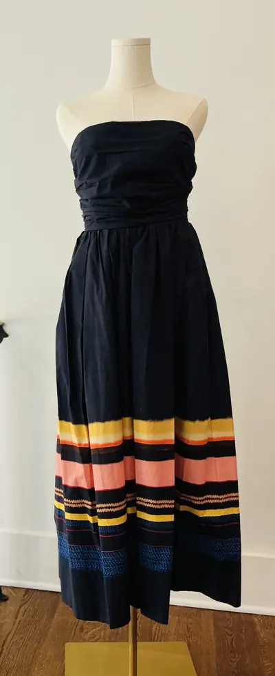 Designer dress on a dress form at Reluxe