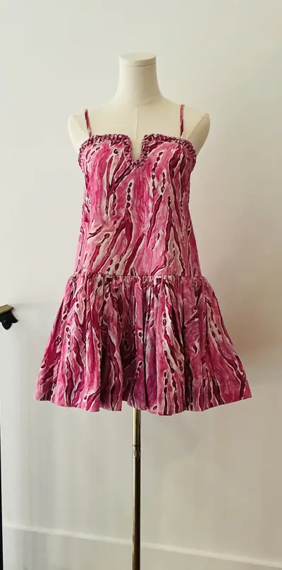 Designer dress on a dress form at Reluxe